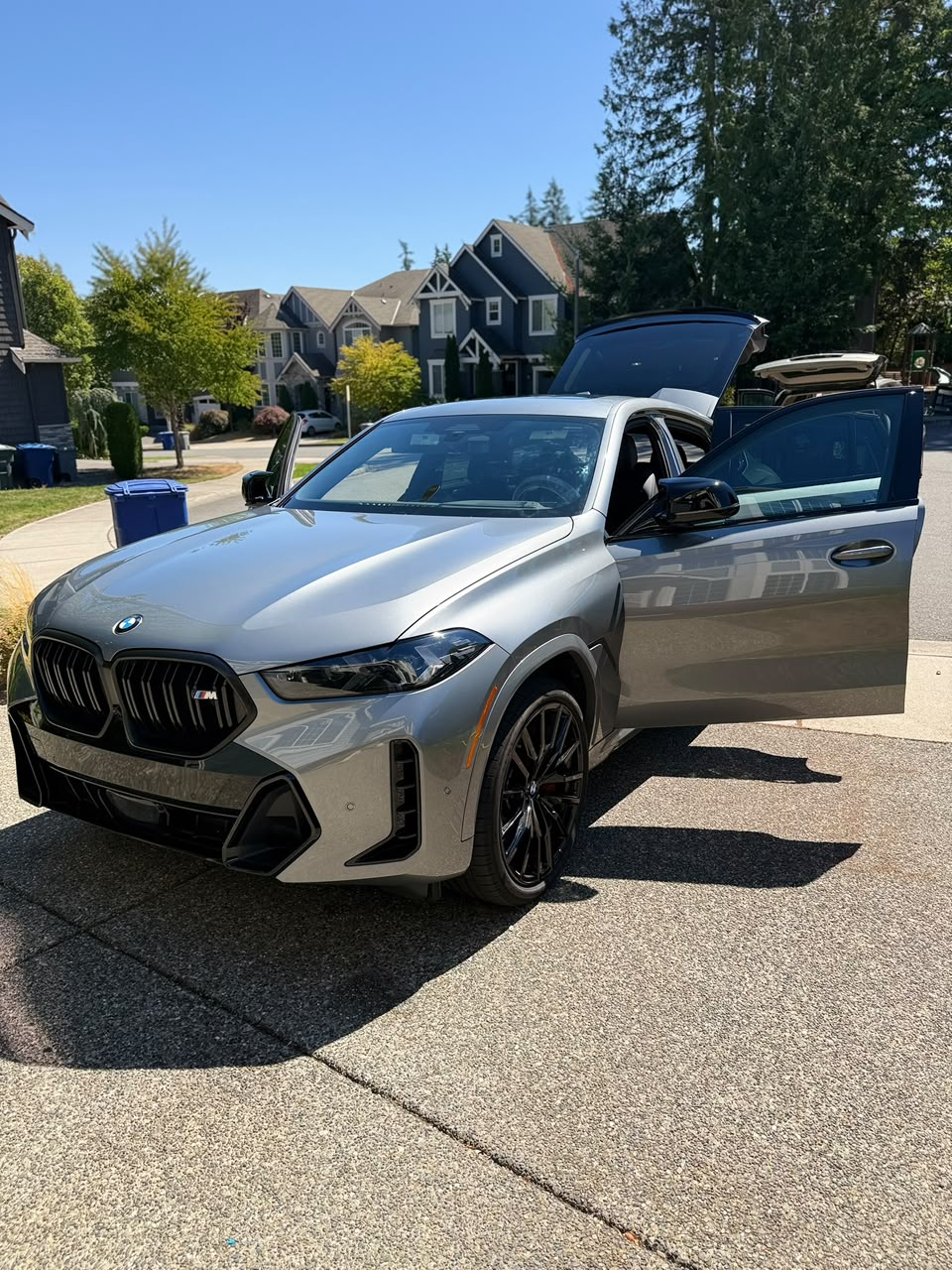 BMW X6 M Competition delivery in Kirkland driveway